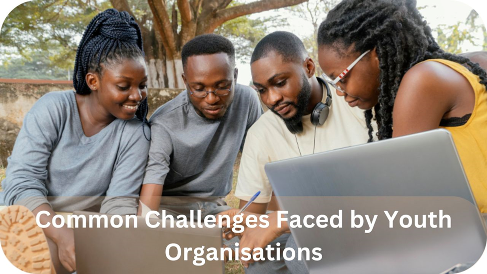 A group of young people discussing challenges in a community meeting.